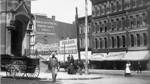 Van Baalen's Loan Office storefront at Michigan Avenue and Lafayette in Detroit, with "Established 1860" visible in the signage, alongside People's Outfitting Co. and other businesses